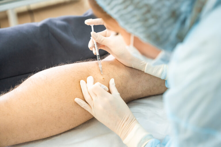 Dermatologist surgeon gives pain relief with an injection instead of surgery, operation process.