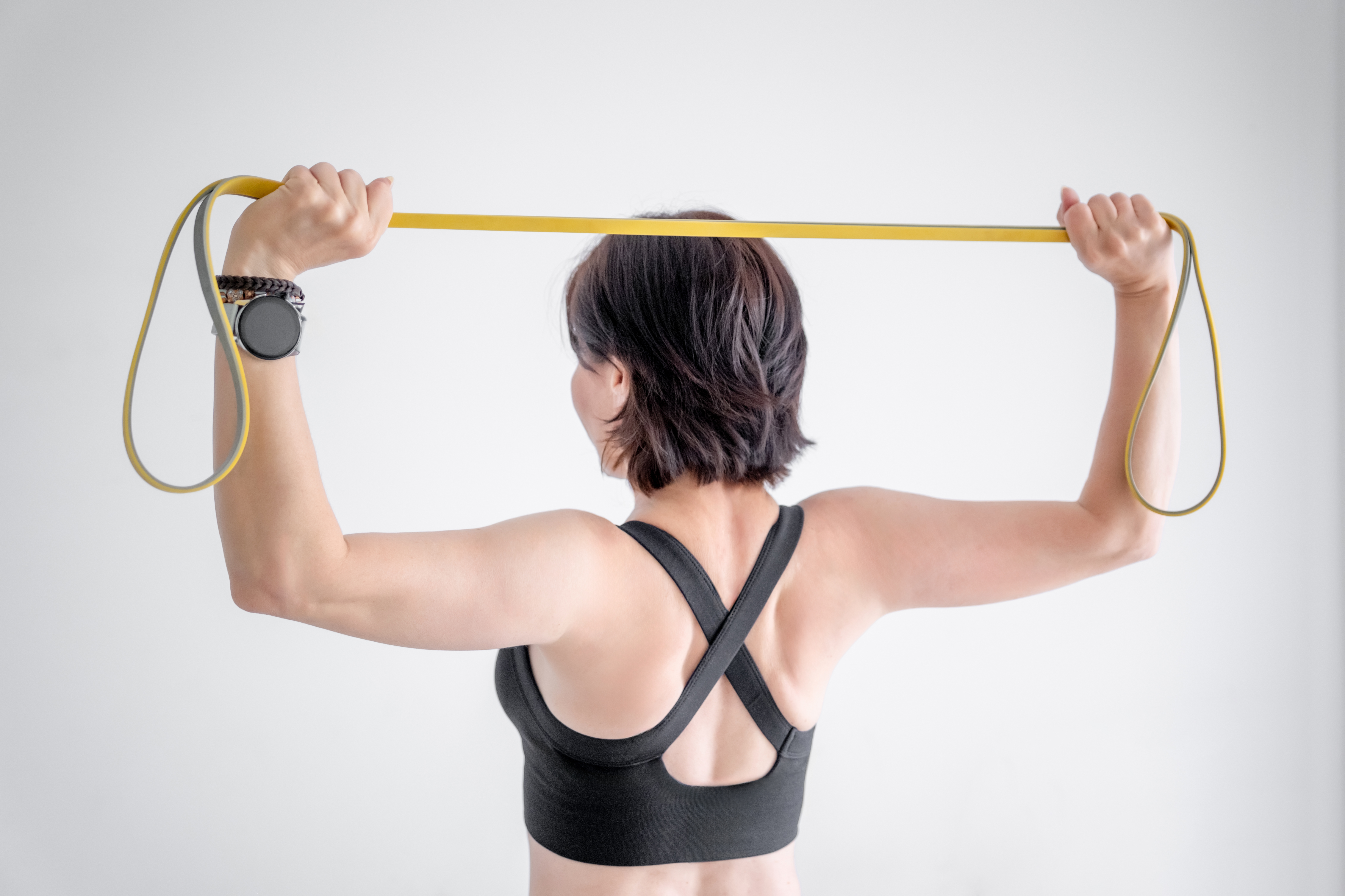 Sport Woman Exercises With Fitness Band, Close-Up Shot Of Hands