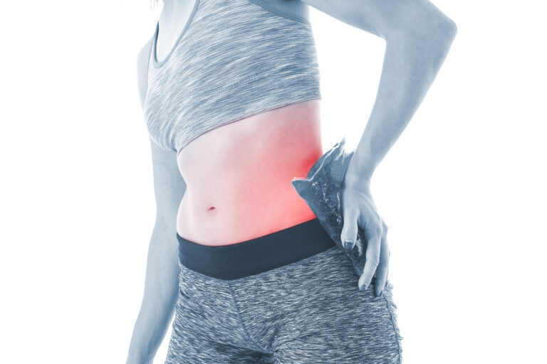 Women holding ice pack to her site at home
